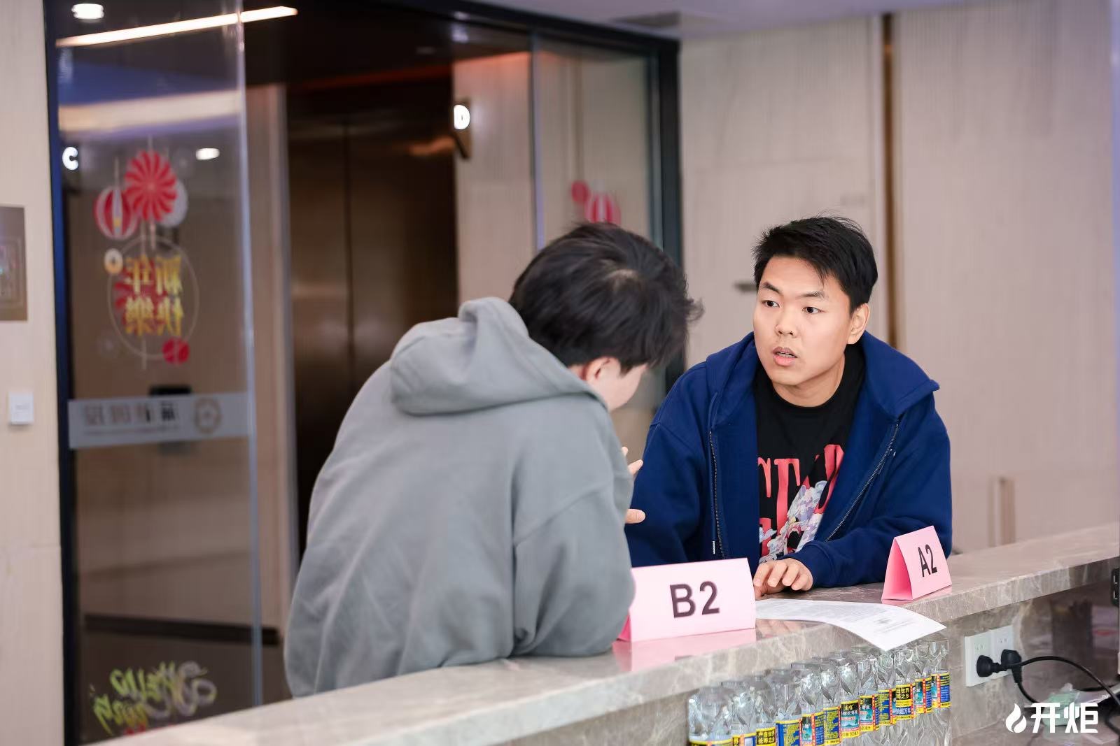 Oliver coaching a student in conversation